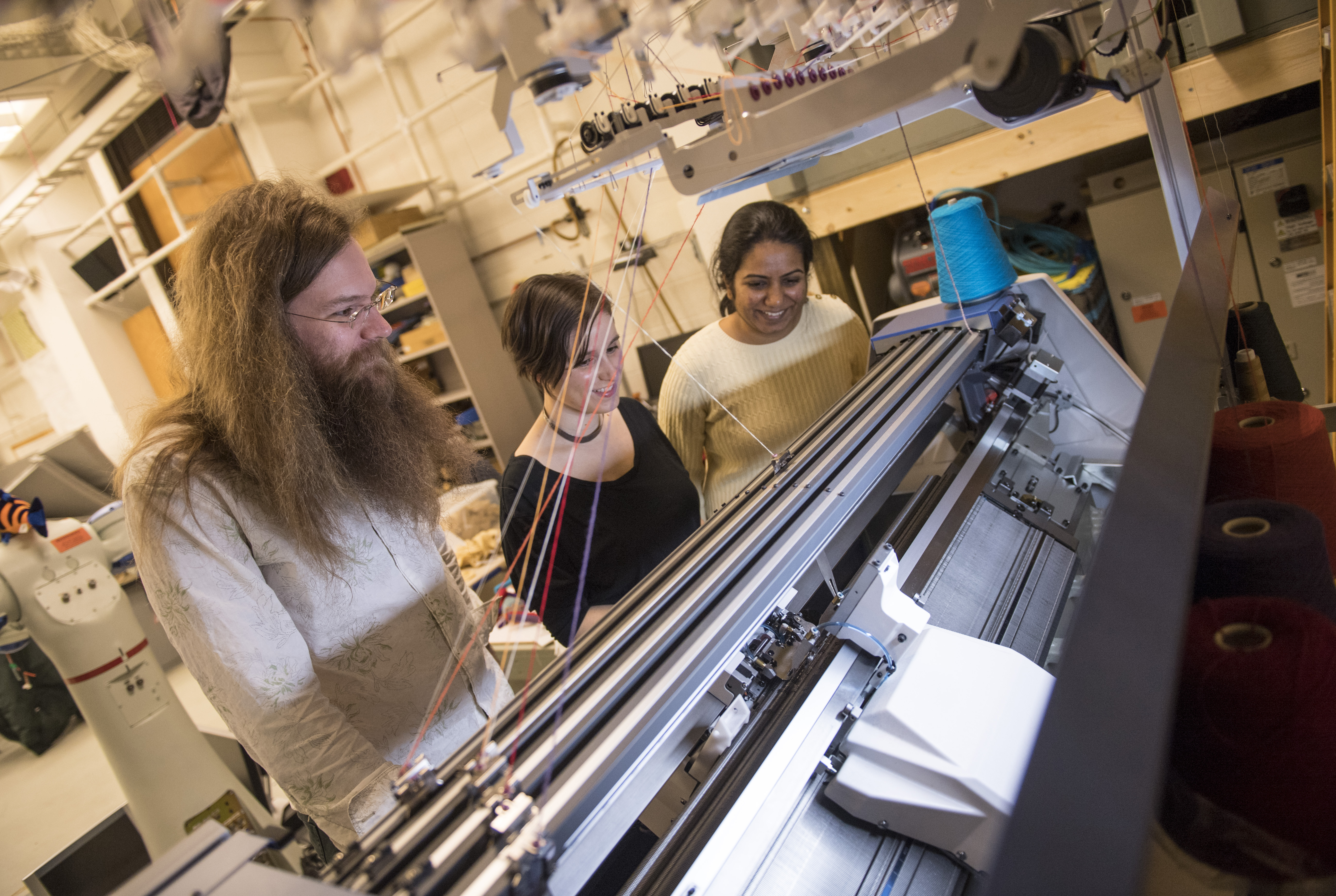 knitting machine being watched by researchers